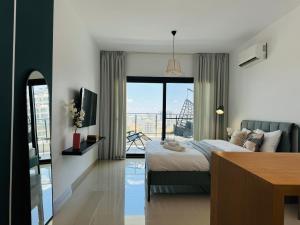 a bedroom with a bed and a window with a view at Seaview stylish one bedroom apartment in Caesar Romulus 88 in Bahçeler +10 photos