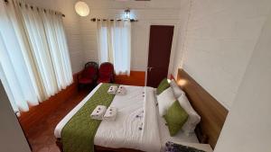 Ένα ή περισσότερα κρεβάτια σε δωμάτιο στο Kuzhupilly Beach House