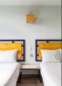 two beds sitting next to each other in a room at Kamya cottage in New Delhi +1 photo