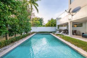 a swimming pool in the backyard of a house at Villa Zenora in Miami