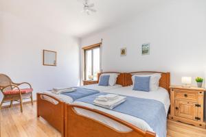 a bedroom with a bed with blue sheets and a chair at Apartment Atlantico, Town Centre in Tavira +39 photos