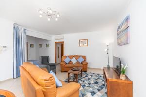 a living room with a couch and a tv at Apartment Atlantico, Town Centre in Tavira