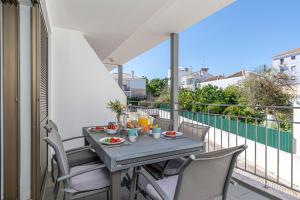 a table and chairs on a balcony with a view of a balcony at Apartment Atlantico, Town Centre in Tavira