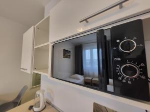 a microwave oven hanging on a wall at VESTA Apartamenty P23 in Szczecin