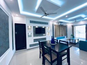 a dining room with a table and a tv at Villa platinum 4 BHK Calangute in Calangute