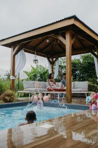 a group of people playing in a swimming pool at Les Villas Mandju in Sainte-Rose