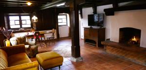 a living room with a couch and a fireplace at Bodenschneidsuiten Das Gschwandler in Tegernsee