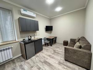 a living room with a couch and a table at Bank Hotel in Yeghegnadzor