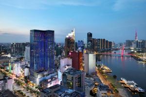a view of a city with a river and buildings at The Reverie Saigon Residential Suites in Ho Chi Minh City