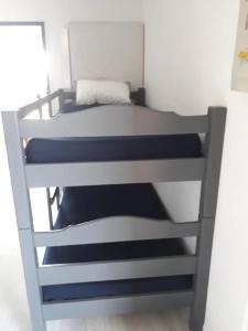 a bedroom with a bunk bed with blue and white sheets at Appartement cosy à Damgan avec vue mer 32 m² in Damgan +18 photos