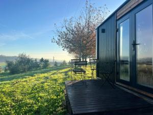 a deck with a table and chairs on a house at Quinta da Runa by Tiny Away in Bagunte