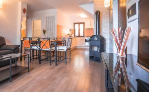 a kitchen and living room with a table and chairs at Serena Charme Green Holiday in Ledro