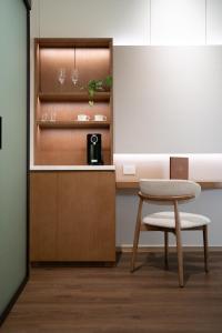 a kitchen with a table and a chair and a counter at NALA Resort in Mission Beach