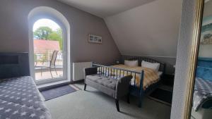 a small bedroom with a bed and a window at Villa Luba in Koserow