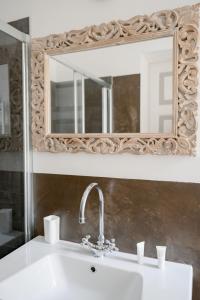 a bathroom with a sink and a mirror at A Casa di Lu Na in Bologna +21 photos