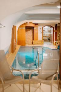a large swimming pool with chairs around it at Duna Wellness Hotel in Baja