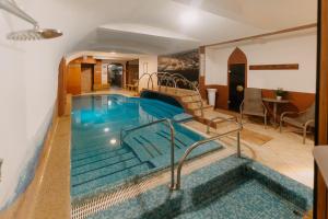 a pool in a hotel room with a swimming pool at Duna Wellness Hotel in Baja