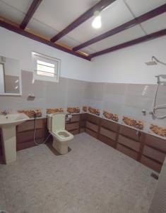 a bathroom with a toilet and a sink at White House Mirissa in Mirissa