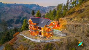 an aerial view of a house on a mountain at Zostel Homes Gadagushaini, Jibhi in Jibhi