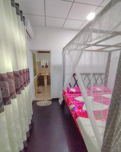 a room with two bunk beds and a table at White House Mirissa in Mirissa