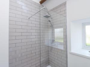 a bathroom with a shower with white tiles at Ty'n Lon Farm in Pwllheli +26 photos