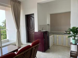 a kitchen with a purple refrigerator in a room at The Ashvem Horizon in Mandrem
