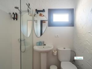 a bathroom with a toilet and a sink and a shower at Living Artenara - EARTH Adults Only in Artenara +56 photos