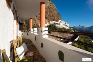 a balcony of a house with a view of a mountain at Living Artenara - EARTH Adults Only in Artenara