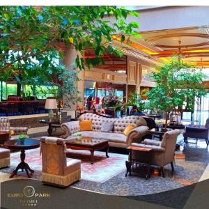 a lobby with couches and tables in a building at Euro Park Otel in Istanbul