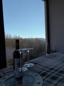 a table with two glasses and a window with a view at Tea House Ponoarele in Ponoarele +24 photos