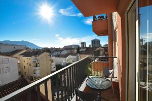a balcony with a table and a view of the city at Apartmani Resna Budva in Budva