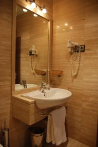 a bathroom with a sink and a mirror at Hostal Los 5 Pinos in Madrid +3 photos