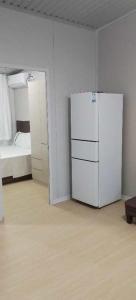 a white room with a refrigerator and a bed at Nadi friendly Apartment --2 bedroom in Nadi