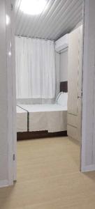 a white room with a bed and a window at Nadi friendly Apartment --2 bedroom in Nadi