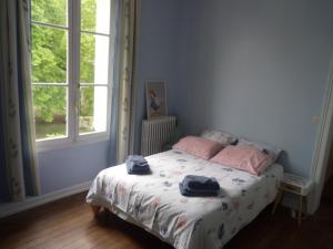 a bedroom with a bed with two towels on it at CHANTOISEAU in Ligueil
