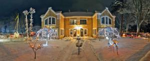 a large house with christmas lights in front of it at Villa Leonardo in Ventspils
