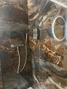 a bathroom with a shower with a stone wall at Magnifique appartement à 300m des plages à Port Frejus in Fréjus