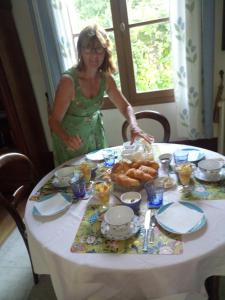 a woman standing in front of a table with food at CHANTOISEAU in Ligueil