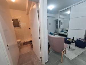 a bathroom with a toilet and a room with a mirror at Cozy studio! in Paphos City +38 photos