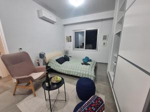 a small room with a bed and a chair at Cozy studio! in Paphos City