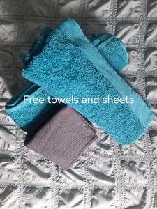 a pair of towels and sheets on a bed at Cozy studio! in Paphos City