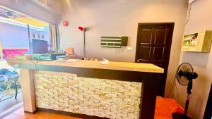 a room with a stone counter with a laptop on it at Hill Side Patong in Patong Beach