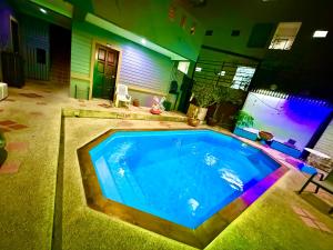 a large swimming pool in the middle of a house at Hill Side Patong in Patong Beach
