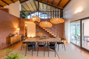 a dining room with a table and chairs and a brick wall at Villa Monasterio in Escobedo