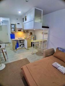 a living room with a bed and a kitchen at Amaia Steps Altaraza by Gem in San Jose del Monte