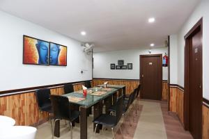 a dining room with a table and chairs at Hotel O The Stay in Kolkata +33 photos