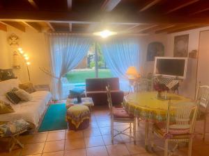 a living room with a couch and a table at Au Petit Bonheur in Cucq