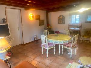 a dining room with a yellow table and chairs at Au Petit Bonheur in Cucq