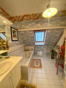 a bathroom with a sink and a bath tub at Au Petit Bonheur in Cucq +9 photos
