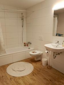 a white bathroom with a toilet and a sink at Harmony Private Single Room Freiburg in Freiburg im Breisgau